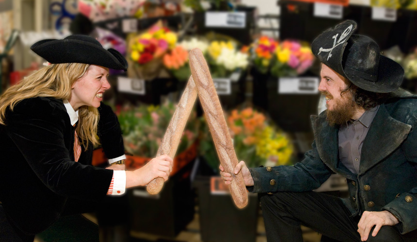 Picture of 2 people dressed as pirates with breadsticks