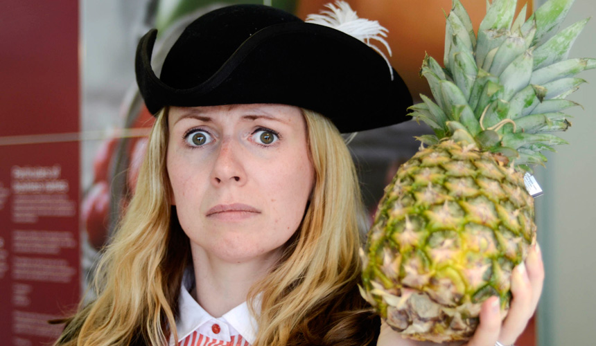 Picture of a woman dressed as a pirate holding a pineapple