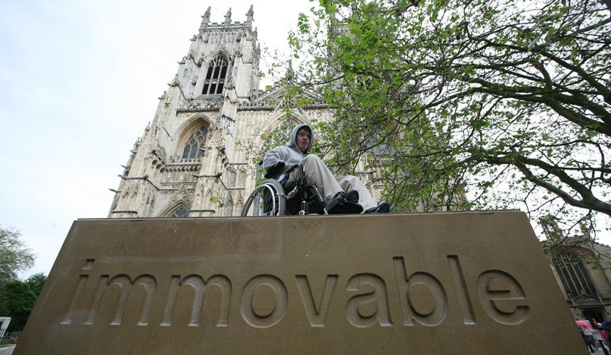 Picture of man in wheelchair on Immovable block