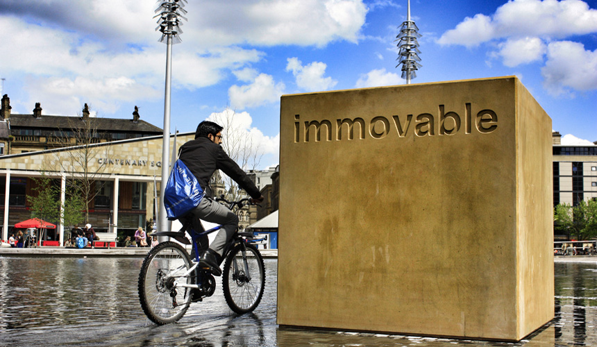 Picture of cycling riding past Immovable block