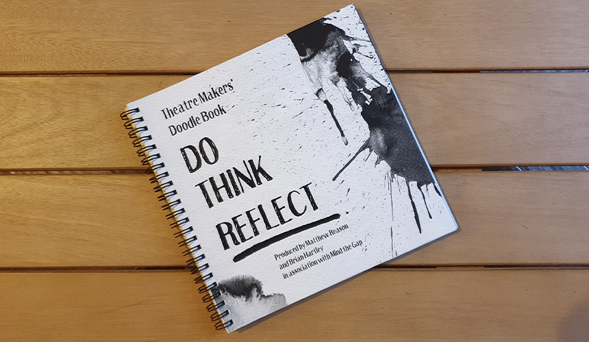 A picture of a book with a black and white cover on a wooden table