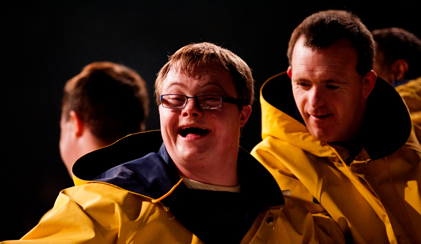 two men in yellow jackets, one is smiling